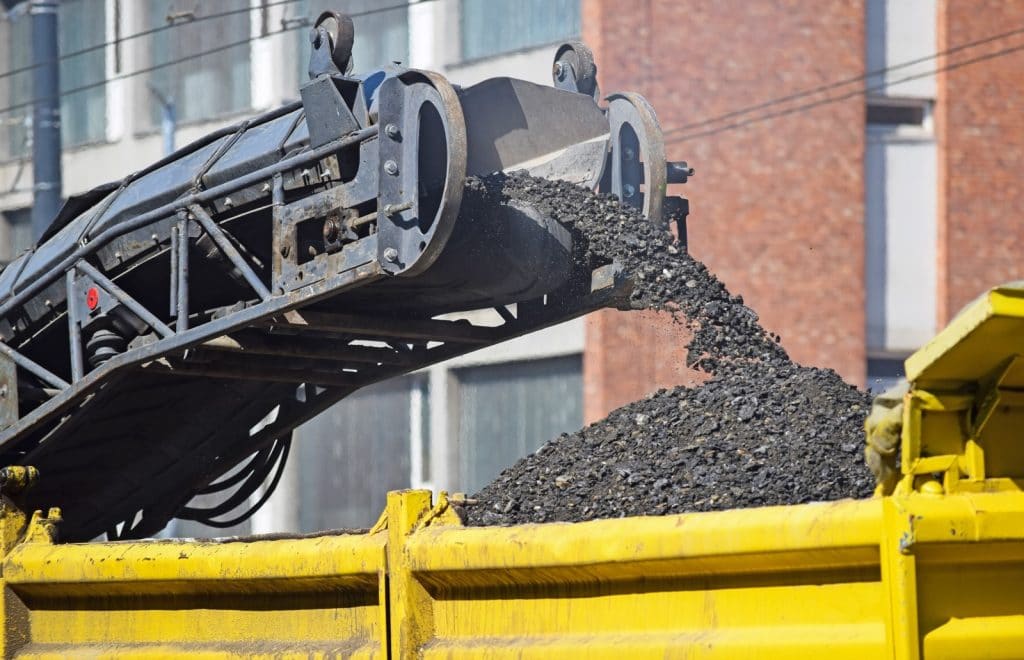 Material flowing on mining conveyor belt.