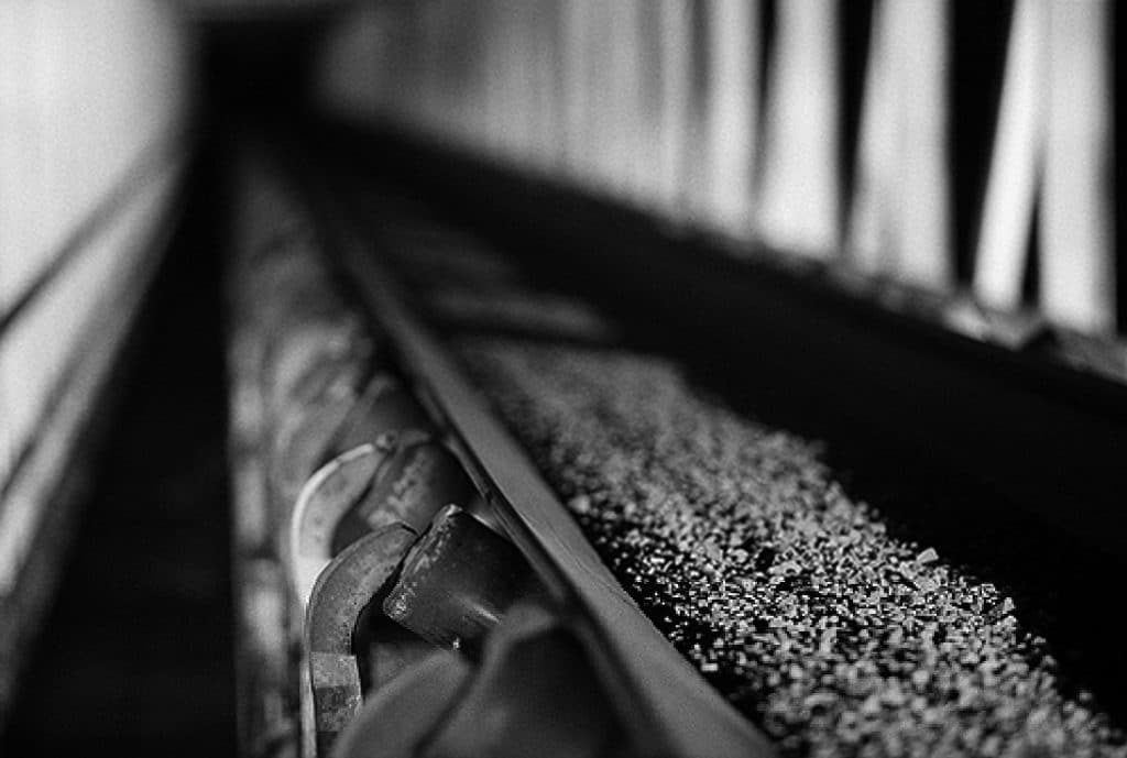 A mining conveyor belt moves materials through an underground conveyor system.