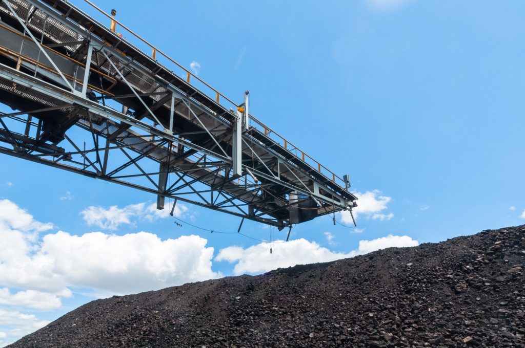A stacker conveyor moving large amounts of coal.