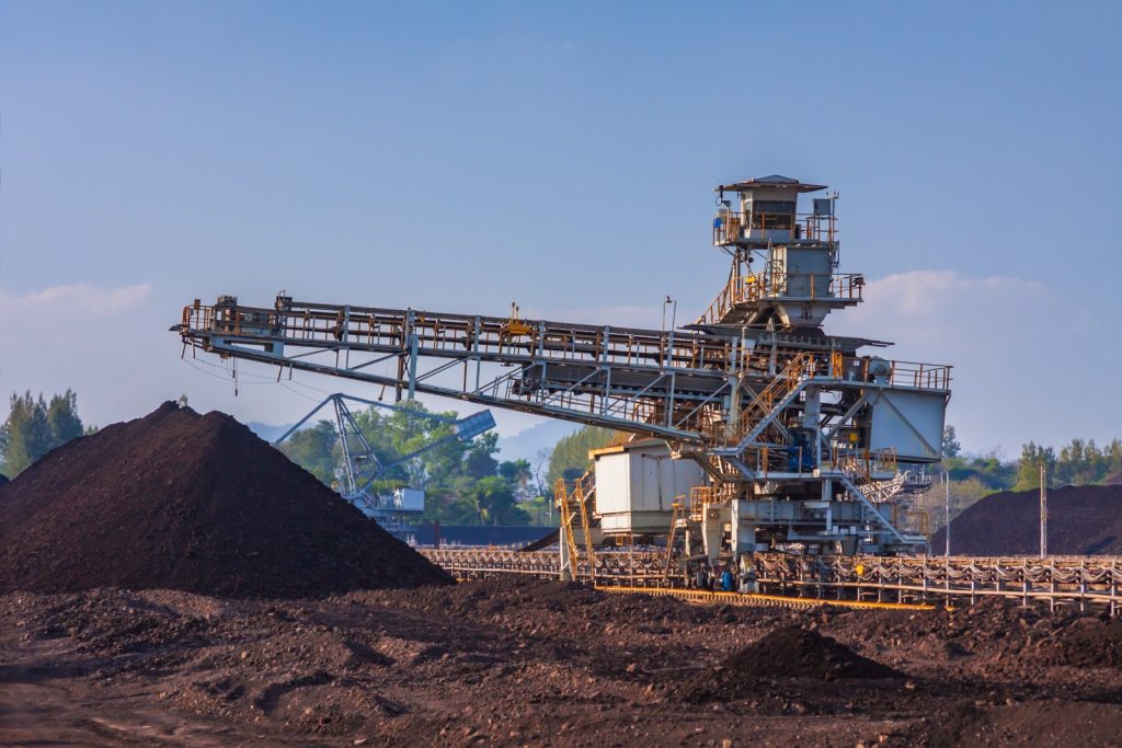 A stacker conveyor moving several tons of coal.