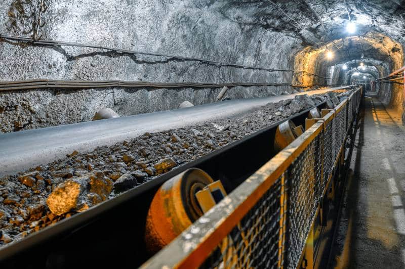 Underground mining conveyor transporting ore