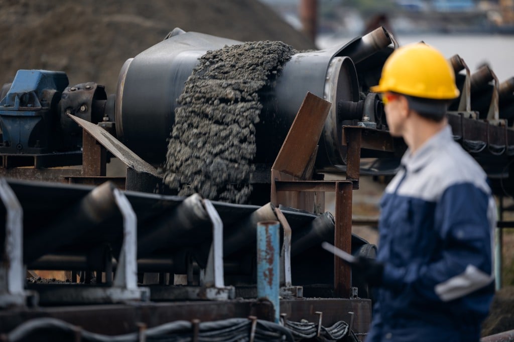 engineer surveying an ore mining conveyor