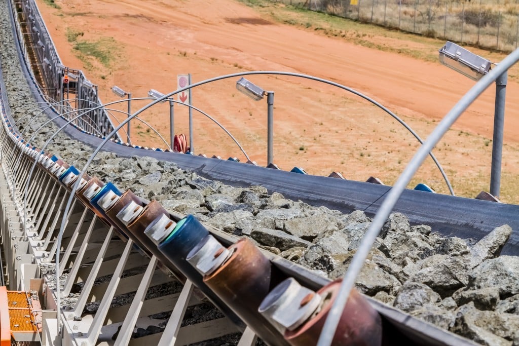 Rock being transported on an overland mining conveyor